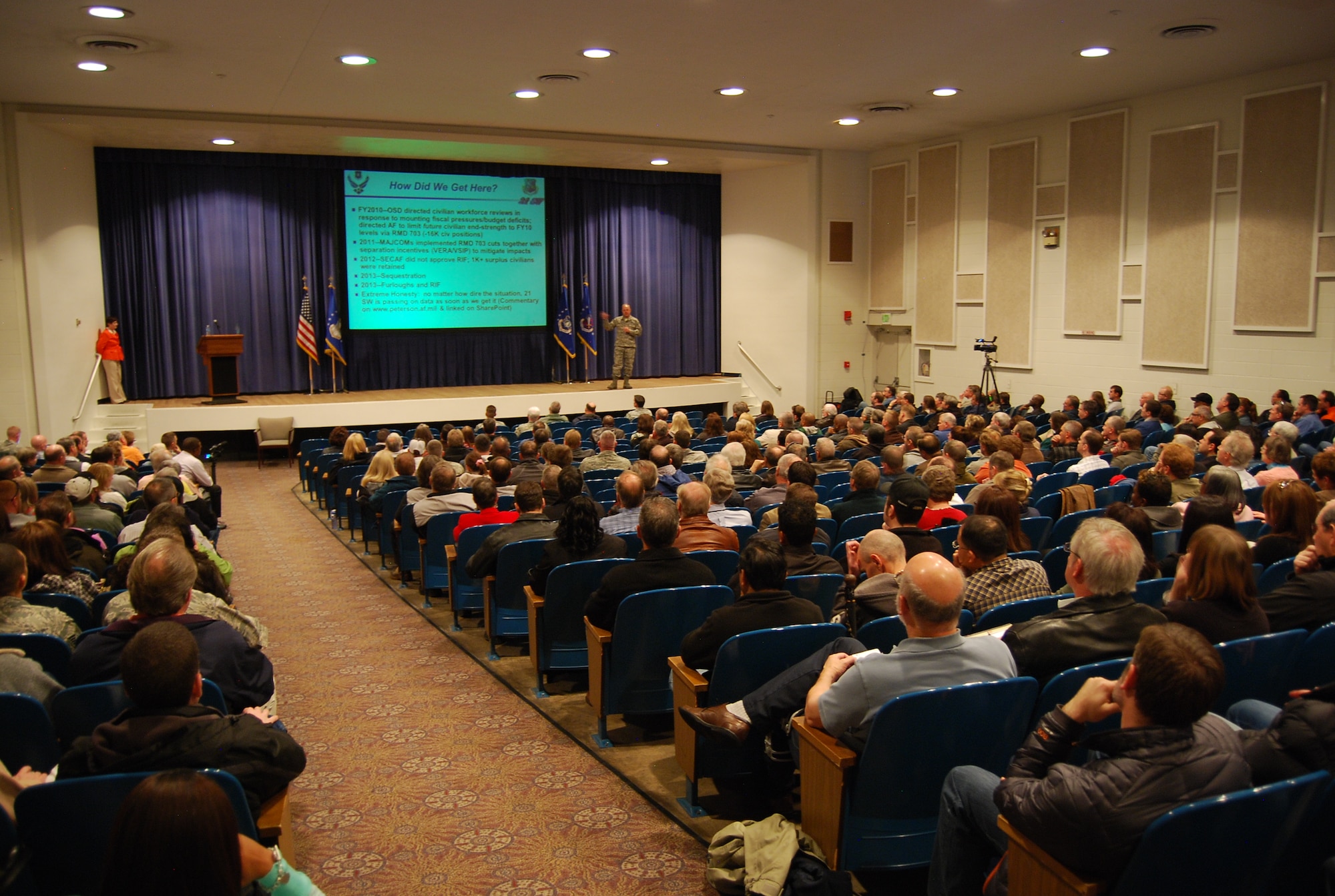 A full house showed up for a civilian commander’s call April 19 at the base auditorium. Col. Chris Crawford, 21st Space Wing commander, addressed civilians’ concerns about a potential reduction in force. (U.S. Air Force photo/Michael Golembesky)