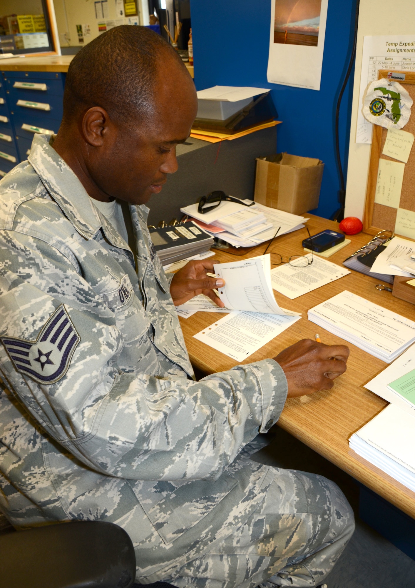 Staff Sgt. Mark O'Neal, 920th Rescue Wing reserve maintenance support section, updates Technical Orders. Technical Orders provide maintenance instructions for repairing HH-60G Pave Hawk helicopters and HC-130P/N King tanker aircraft.  Updating TOs as they are now -- paper pages in a four-inch thick binder -- is an all-day job. Using the eTools Lite software, loaded onto Apple iPads, to update the TOs will save O'Neal six hours a day. The 920th RQW is among the first to use this technology. (U.S. Air Force photo/2nd Lt. Leslie Forshaw)