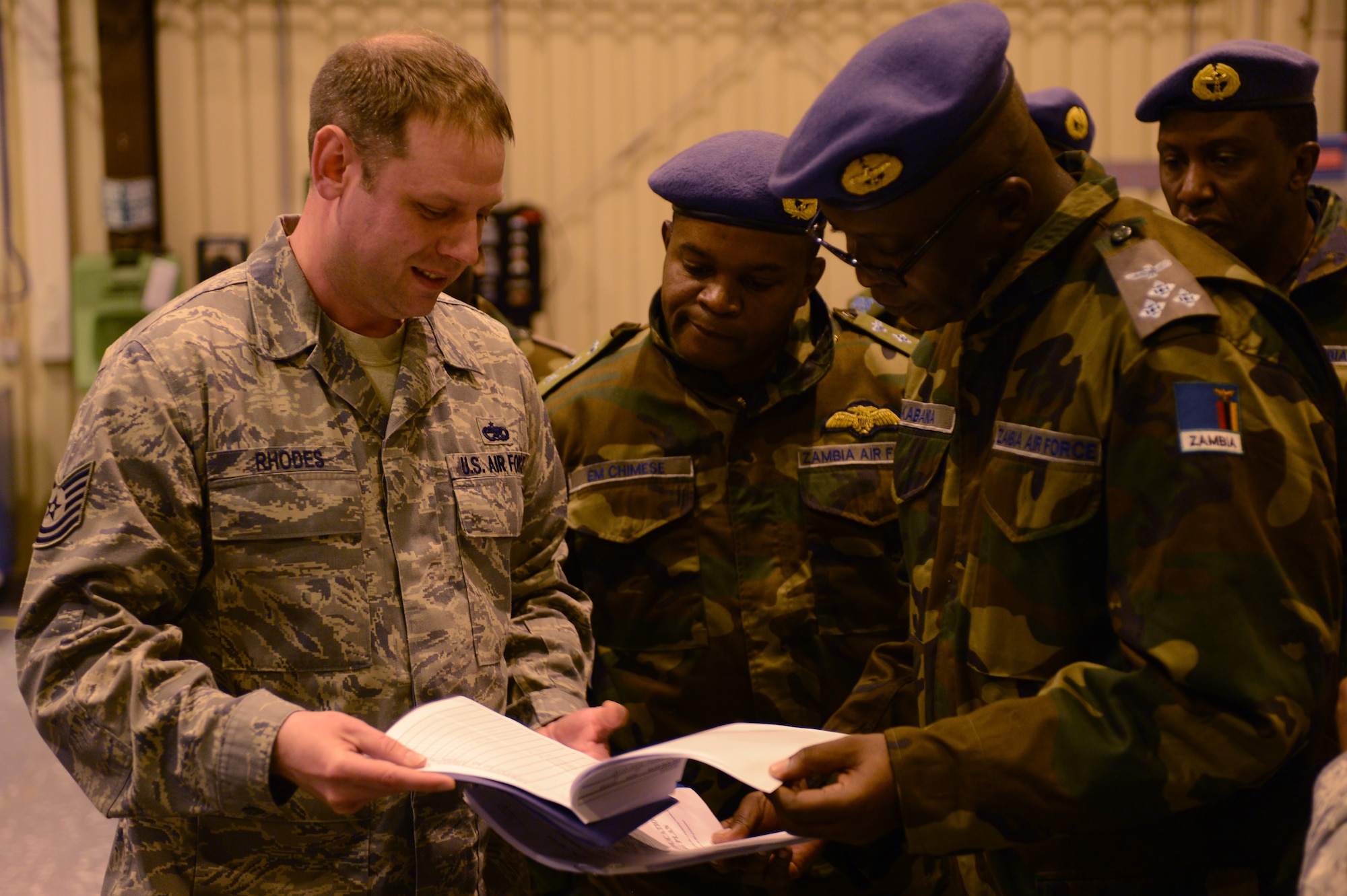 Tech. Sgt. Michael Rhodes, 86th Maintenance Squadron aircraft structural maintenance section chief, provides information to Zambian air forces on the technical training an Air Force Airman receives, May 1, 2013, Ramstein Air Base, Germany. The visit gave the Zambian air force a chance to further military relations and improve the partnership between the U.S. and Zambian air forces. (U.S. Air Force photo/Senior Airman Caitlin O’Neil-McKeown)