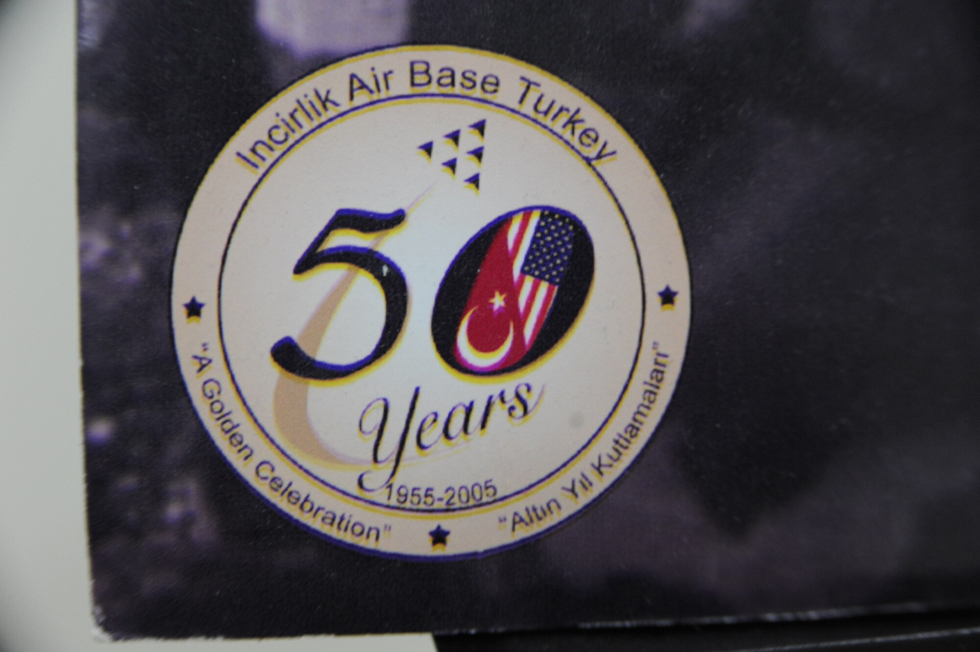 A graphic on a poster board commemorating Incirlik Air Base celebrating its 50th anniversary in 2005 sits at the top of a flight of stairs in the 39th Air Base Wing headquarters building at Incirlik Air Base, Turkey, May 2, 2013. Local sources have confirmed this picture has been on display for the past eight years. (U.S. Air Force photo by 1st Lt. David Liapis/Released)
