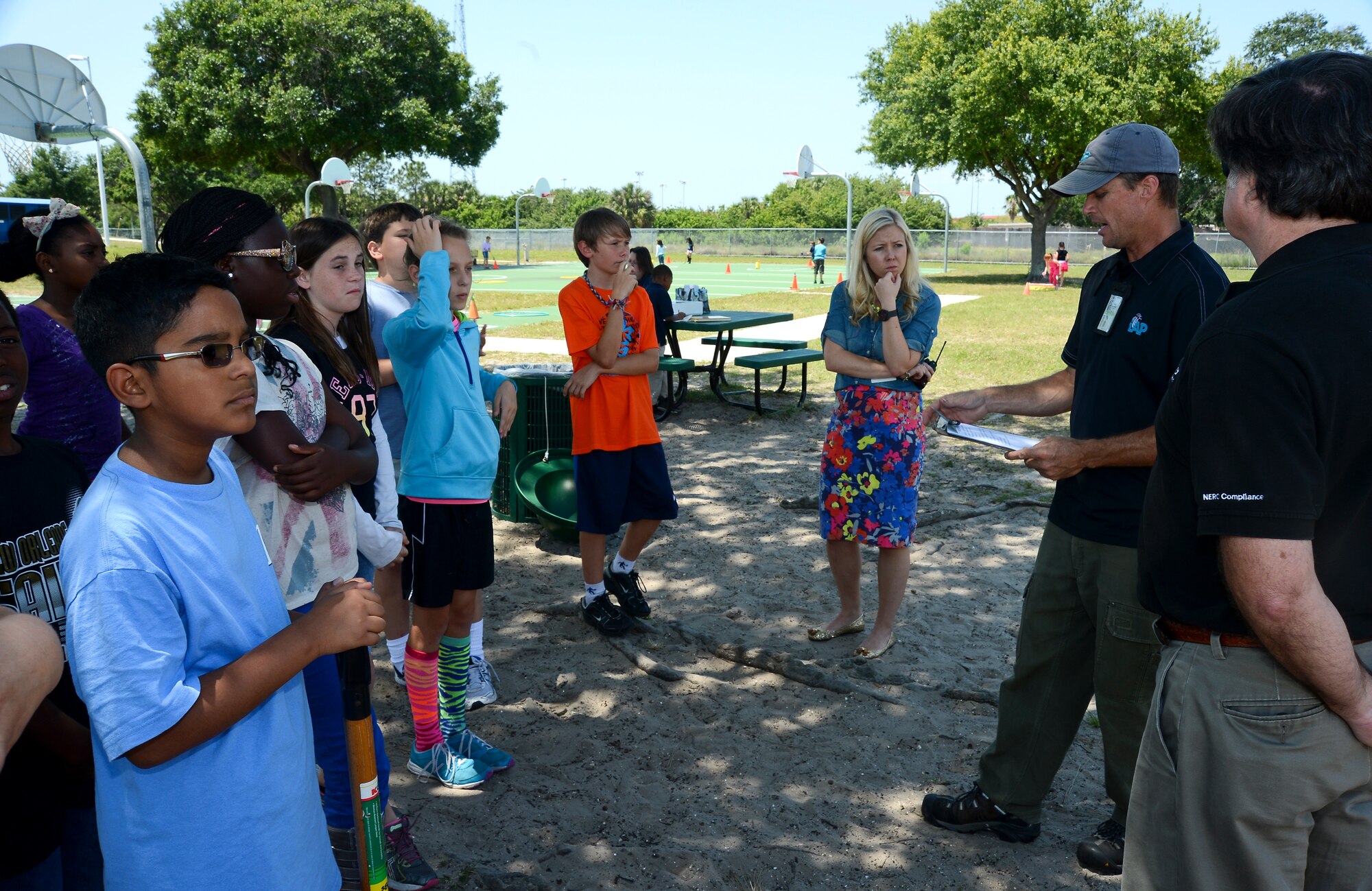 Jason Kirkpatrick, 6th Civil Engineer Squadron contractor, discusses with the Tinker Elementary School 5th graders the importance of trees in the community at MacDill Air Force Base, Fla. on April 26, 2013. The students were preparing to plant trees around the school playground to celebrate Arbor Day at MacDill. (U.S. Air Force photo by Senior Airman Shandresha Mitchell/ Released)