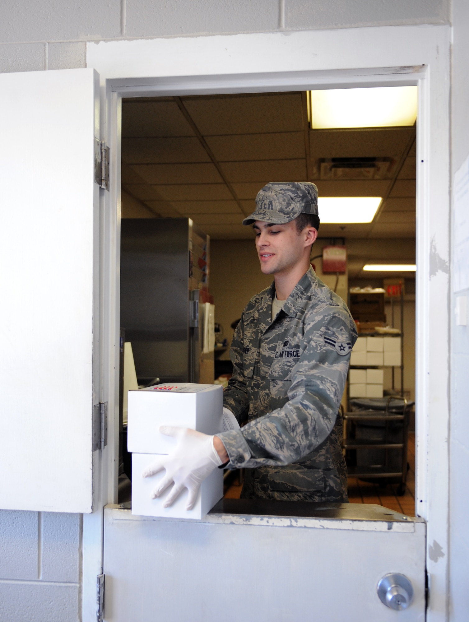 Airman 1st Class Michael Bucher, 2nd Force Support Squadron food services, prepares a to-go box at the Touch-N-Go flight kitchen on Barksdale Air Force Base, La., May 6, 2013. The flight kitchen gives Airmen and aircrew on the flightline a chance to grab food when the mission makes it difficult to take a full lunch. (U.S. Air Force photo/Airman 1st Class Benjamin Gonsier)
