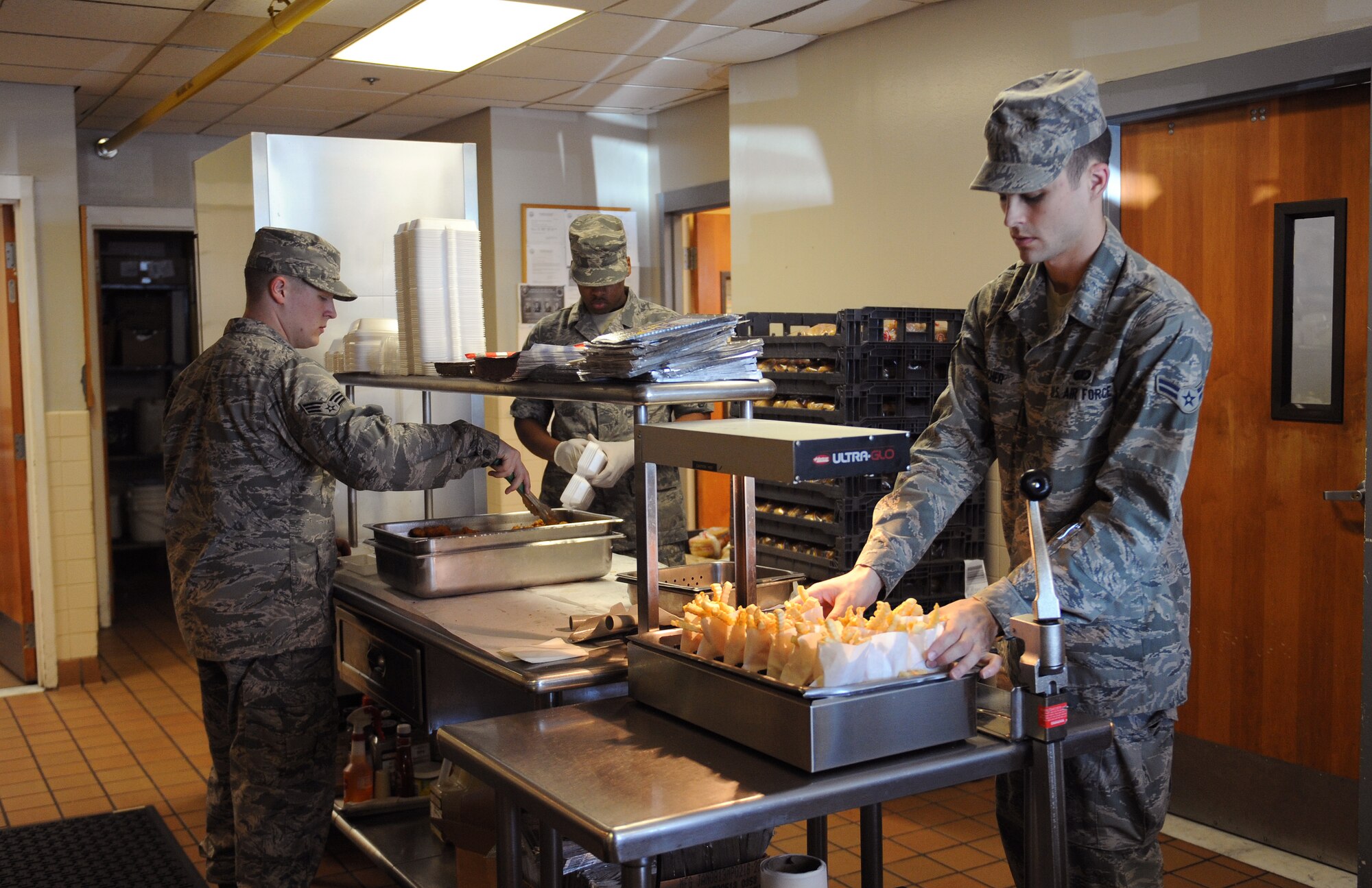 Airmen from the 2nd Force Support Squadron Touch-N-Go flight kitchen prepare food on Barksdale Air Force Base, La., May 6, 2013. The flight kitchen gives Airmen and aircrew on the flightline a chance to grab food when the mission makes it difficult to take a full lunch. (U.S. Air Force photo/Airman 1st Class Benjamin Gonsier)
