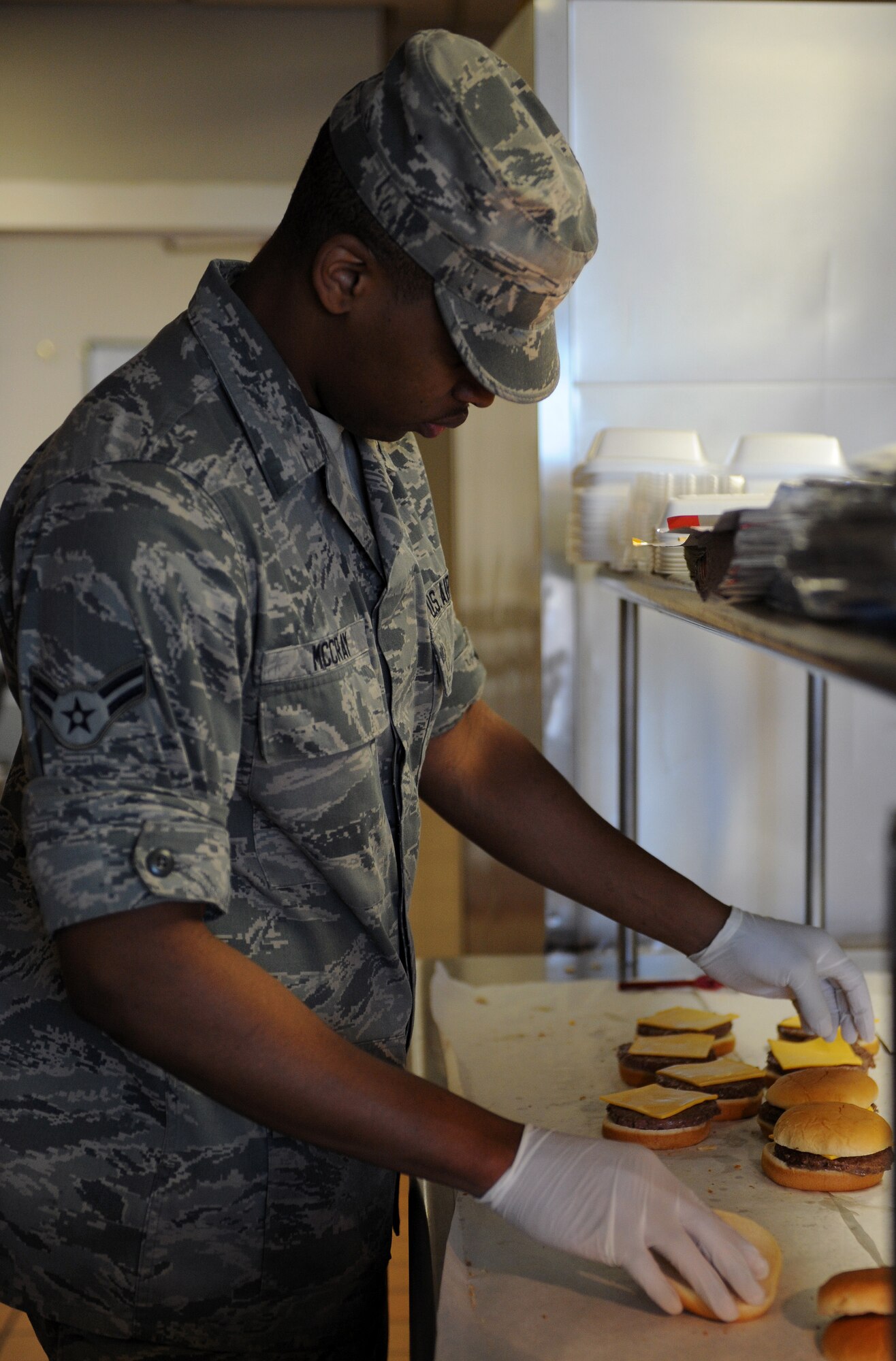 Airman 1st Class Yontaireus McCray, 2nd Force Support Squadron food services, prepares cheeseburgers at the Touch-N-Go flight kitchen on Barksdale Air Force Base, La., May 6, 2013. The flight kitchen serves breakfast from 6 to 8 a.m., lunch from 11 a.m. to 1:30 p.m. and dinner from 3:30 to 7 p.m. After dinner, the flight kitchen's dining room is closed but Airmen are still able to order box meals from the pick-up window. (U.S. Air Force photo/Airman 1st Class Benjamin Gonsier)
