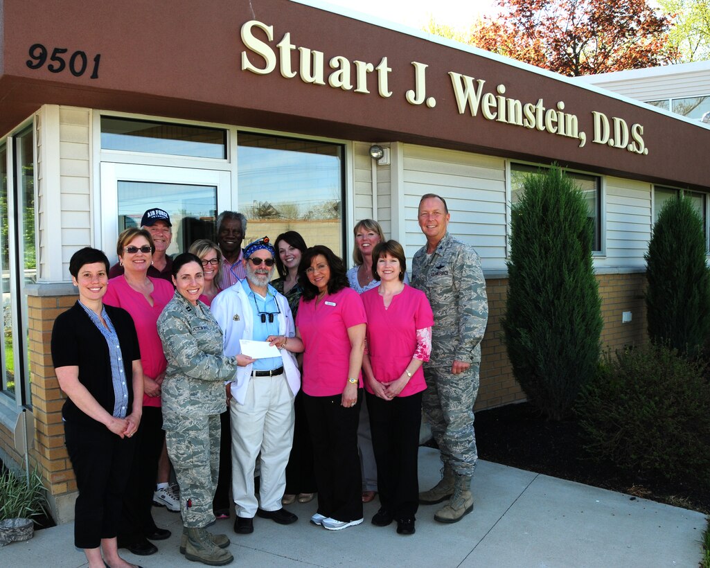 (L to R) Ms. Megan Calero, 914th Airlift Wing Life/Work Consultant, Ms. Susan Yuroshoski , Advanced Dental, Mr. Gregory Hood, patient, Capt. Gina Pizziconi-Cupples, 914th Logistics Readiness Squadron Commander, Ms. Wendy Mariano, Advanced Dental, Mr. Ron Bassham, patient, Dr. Stuart Weinstein, Ms. Laura Hood, Ms. Marygrace Scarpelli of Advanced Dental,  Mrs. Lana Swartzmiller, Ms. Carla Siwinski, Advanced Dental and Col. Allan Swartzmiller, 914th Airlift Wing Commander pose for a group photo at the Advanced Dental  Office in Niagara Falls, N.Y. on May 6, 2013. Dr. Weinstein and his staff presented a check of proceeds collected from their Operation Whiter-Brighter Campaign. Each year several thousands of dollars are collected to be used for various programs to benefit local military members and their families. (U.S. Air Force photo by Peter Borys.)