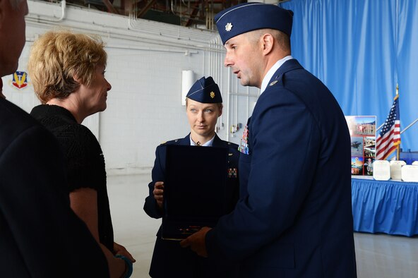 U.S. Air Force Lt. Col. Johnny Vargas, 77th Fighter Squadron commander hands a medal to the mother of Capt. James Steel, 77th Fighter Squadron pilot, during a memorial ceremony at Shaw Air Force Base, S.C., April 30, 2013.  The memorial ceremony commemorated the life and accomplishments Steel, who died in an F-16 Fighting Falcon aircraft accident, while deployed to Afghanistan.  (U.S. Air Force photo by Airman 1st Class Nicole Sikorski/Released)
