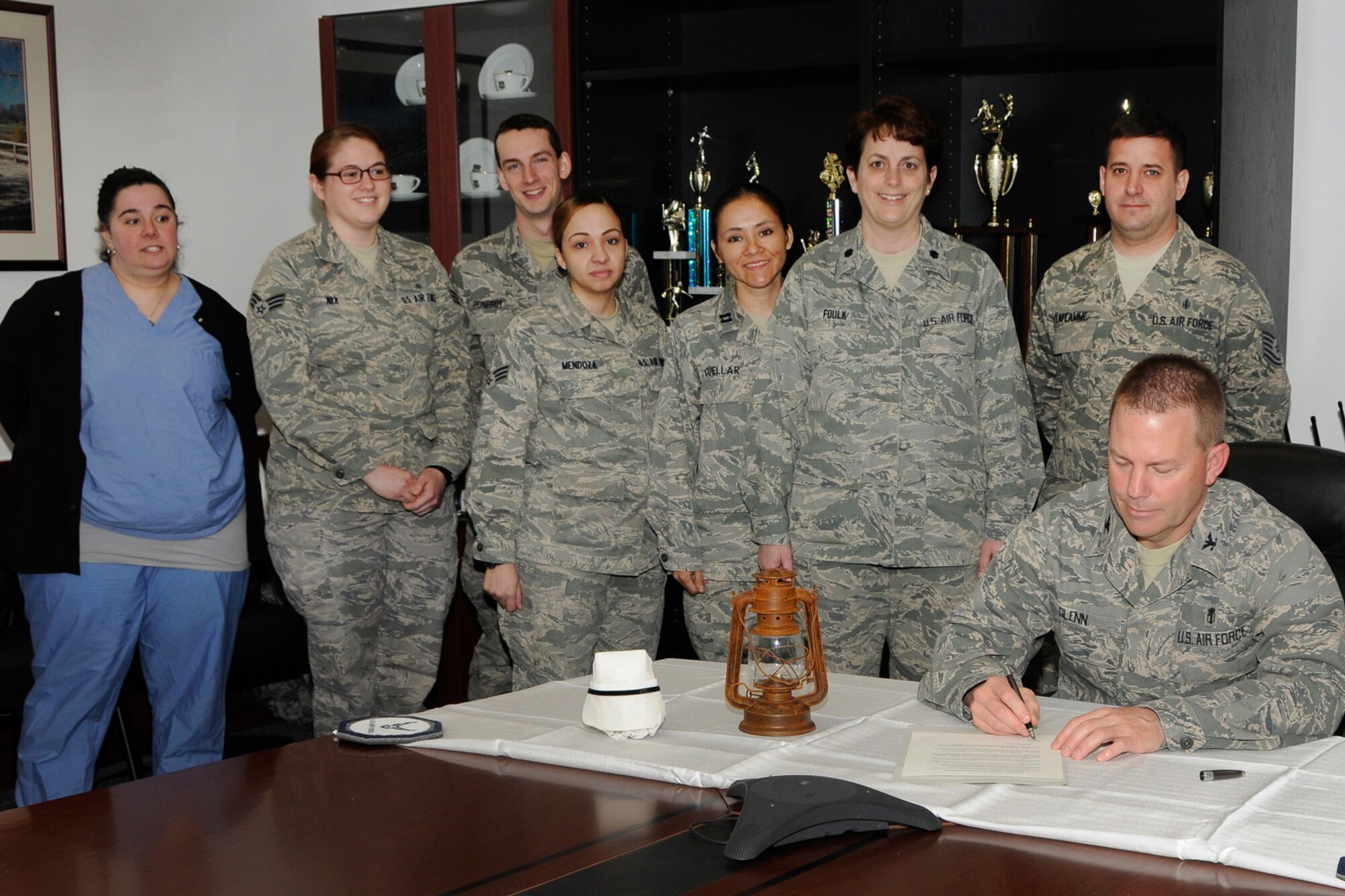 HANSCOM AIR FORCE BASE, Mass. -- Col. Frank Glenn, 66th Medical Squadron commander, signs a proclamation celebrating May 6 as National RN Recognition Day and the start of National Nurses, Technician Week as squadron personnel look on.  National Nurses, Technicians Week takes place annually May 6 to May 12 and recognizes the dedication, commitment and tireless efforts of the nurses and technicians here. (U.S. Air Force photo by Linda LaBonte Britt) 