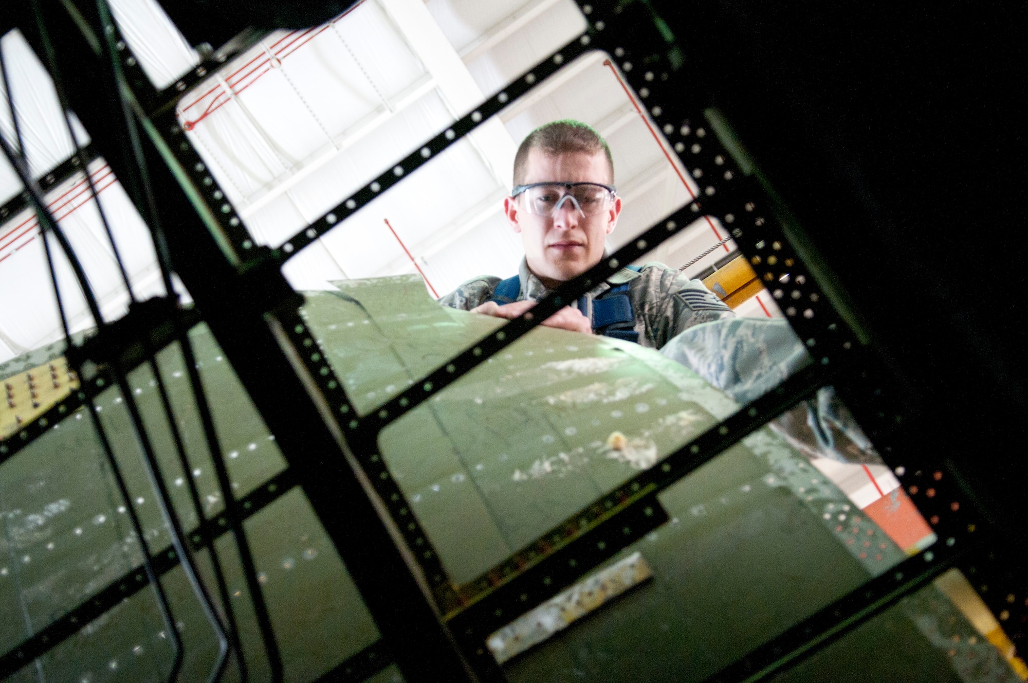 Tech. Sgt. Ron Glazer Jr. peels back a panel on a C-5A aircraft as part of a crown skin repair being accomplished by the aircraft structural maintenance shop at the 167th Airlift Wing, May 5. This particular repair is typically accomplished at the depot level.
(Air National Guard photo by Tech. Sgt. Michael Dickson/Released)
