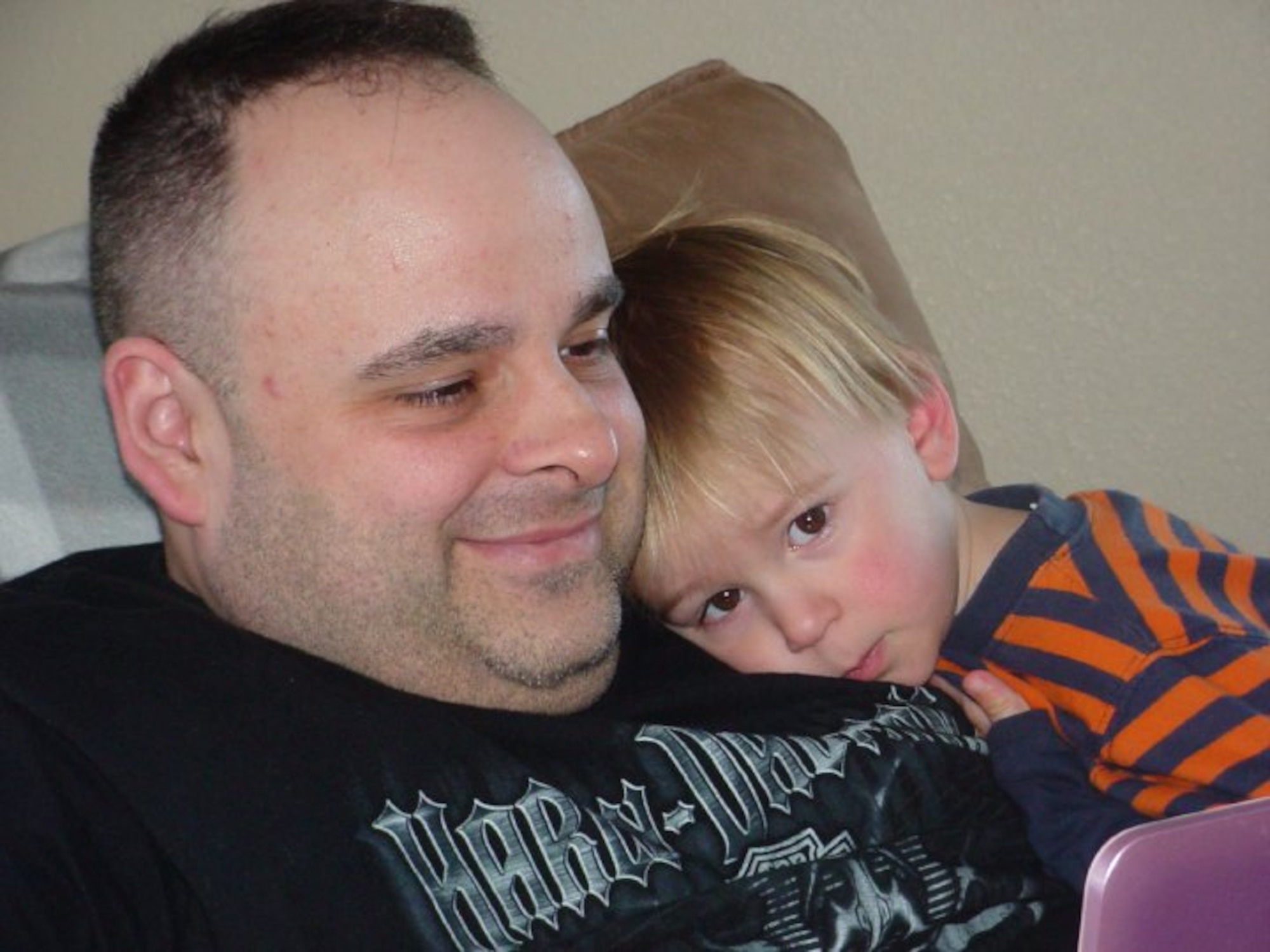 Air Force Master Sgt. Shane Sullivan, 380th Air Expeditionary Wing Equal Opportunity officer, sits with his son prior to his decision to get healthy. Sullivan lost more than 40 pounds, won the wing's Biggest Loser competition and scored a 99.8 on his fitness test during his deployment. (Courtesy photo)