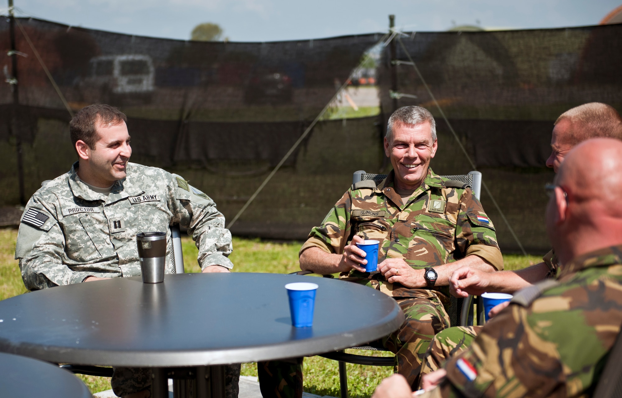 U.S. Army Capt. Adam Proctor, 1st Netherlands Ballistic Missile Defense Task Force Dutch missile systems tactical director, enjoys a coffee break with Dutch army soldiers  April 26, 2013, at Incirlik Air Base, Turkey. Though Proctor is part of the U.S. military, he is currently assigned to the Dutch military as a foreign exchange officer and deployed to Incirlik as part of the NATO commitment to deter hostile actions near the Turkish-Syrian border. (U.S. Air Force photo by Senior Airman Daniel Phelps/Released)