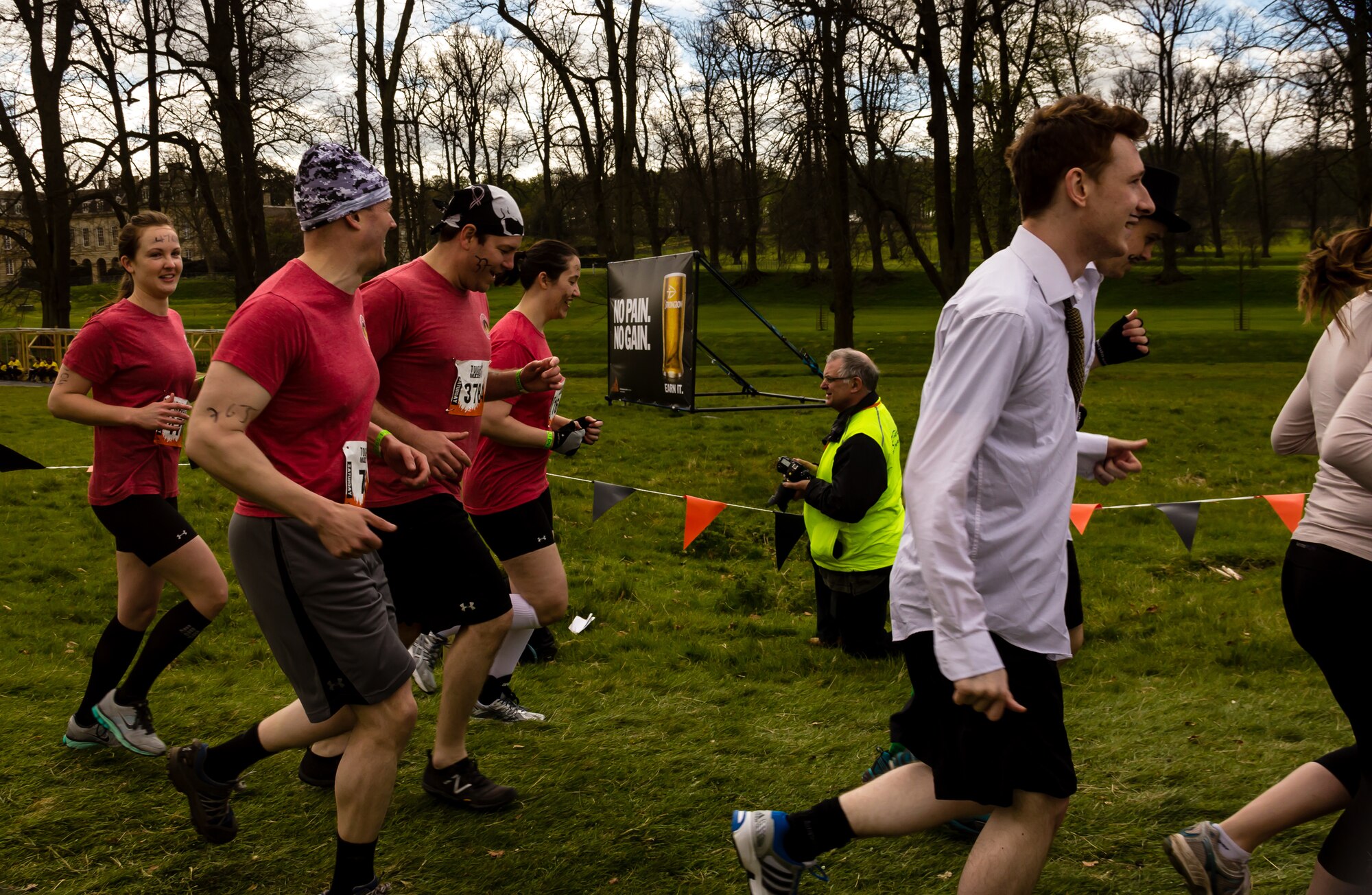 KETTERING, United Kingdom – (left to right in red) Miranda Jasper, U.S. Army Maj. Derek Bickler, Richard “Wolfie” Hammerbacker and Jessica Reidy run between obstacles during the “Tough Mudder” 2013 extreme sports challenge at Boughton House in Kettering, Northhamptonshire, May 4. The four-member Team Molesworth joined more than 15,000 participants in a grueling 12-mile, 22-obstacles course designed by elite Special Forces units to test speed, stamina, teamwork and sheer willpower. (Photo by CA Eccles)