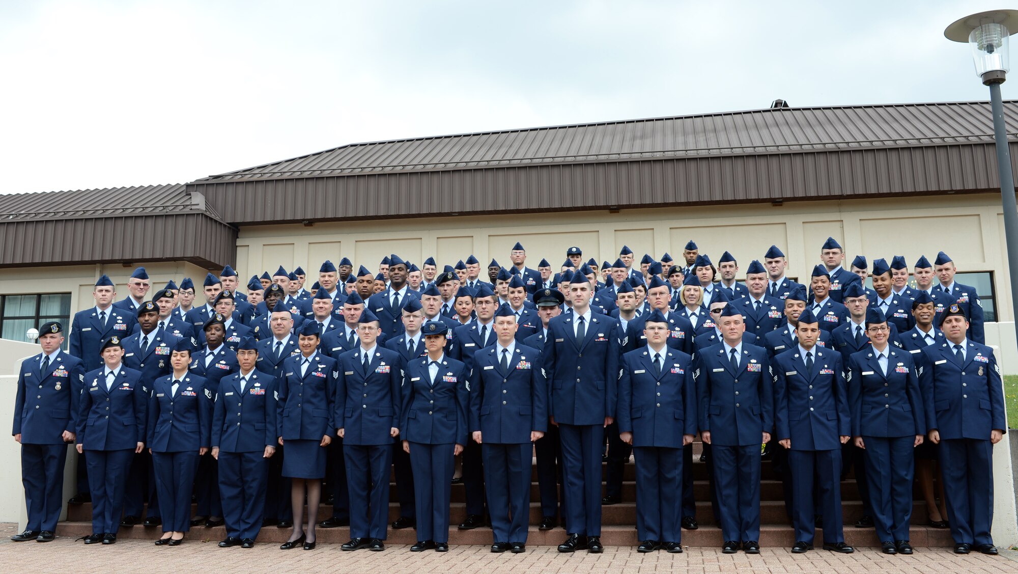 Members of the spring Community College of the Air Force graduating class pose for a group photo, May 3, 2013, Ramstein Air Base, Germany. With 310 Airmen recieving degrees, this class is the largest to graduate on Ramstein. (U.S. Air Force photo/Senior Airman Caitlin O’Neil-McKeown)