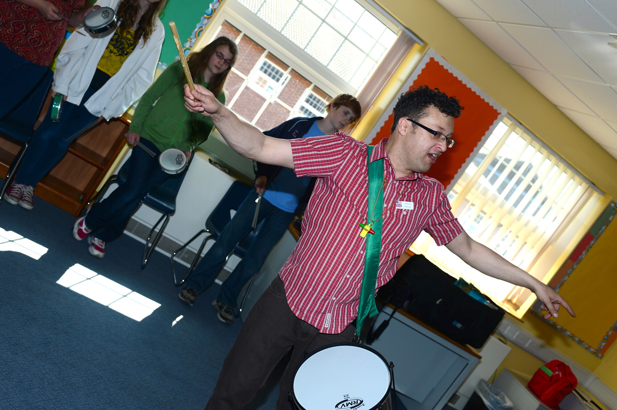 ROYAL AIR FORCE FELTWELL, England -- Anthony Paul teaches Lakenheath Middle School students the history of samba drumming in the U.K. during U.K. Day May 3, 2013. Middle school students learned about the history and culture of England through activities ranging from medieval re-enactments to a U.K. police demonstration. U.K. Day compiles years of British history and culture into one day filled with events and activities that are both fun and educational. (U.S. Air Force photo by Airman 1st Class Dana J. Butler)