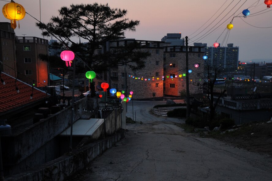 Lanterns strung throughout a city street line the way to the Song Dok Sa Temple near Osan Air Base, Republic of Korea, May 4, 2013. In Buddhism, the lanterns light up the darkness and allow for self-reflection to guide the way to enlightenment. (U.S. Air Force photo/Senior Airman Alexis Siekert)