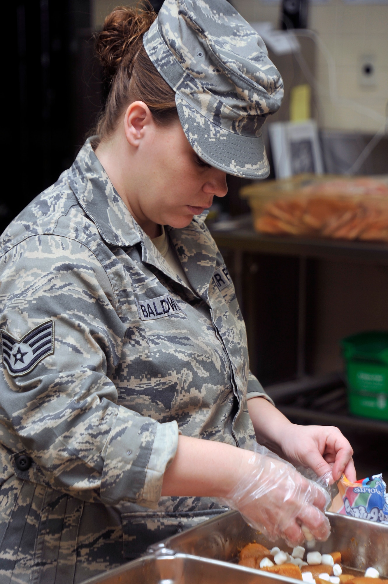 U.S. Air Force Staff Sgt. Jessica Baldwin, 35th Force Support Squadron food services shift leader, adds marshmallows to sweet potatoes in the Grissom Dining Facility kitchen while preparing for lunch at Misawa Air Base, Japan, April 18, 2013. Food services Airmen begin preparing meals at the dining facility about an hour and a half before the first customer is served.  (U.S. Air Force photo by Airman 1st Class Zachary Kee)