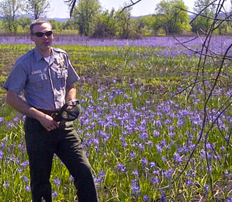Natural Resource Specialist Cameron Bishop shows off an area near Fern Ridge Reservoir west of Eugene, Ore., that was treated with prescribed fire last fall and now is bursting with camas and other plants.

The Willamette Valley was once dominated by prairies with a rich diversity of grasses and wildflowers. This ecosystem requires regular disturbance – historically provided by native people through regular intentional burning – to maintain these native species, prevent forest encroachment and reduce wildfire risks to the surrounding communities.
