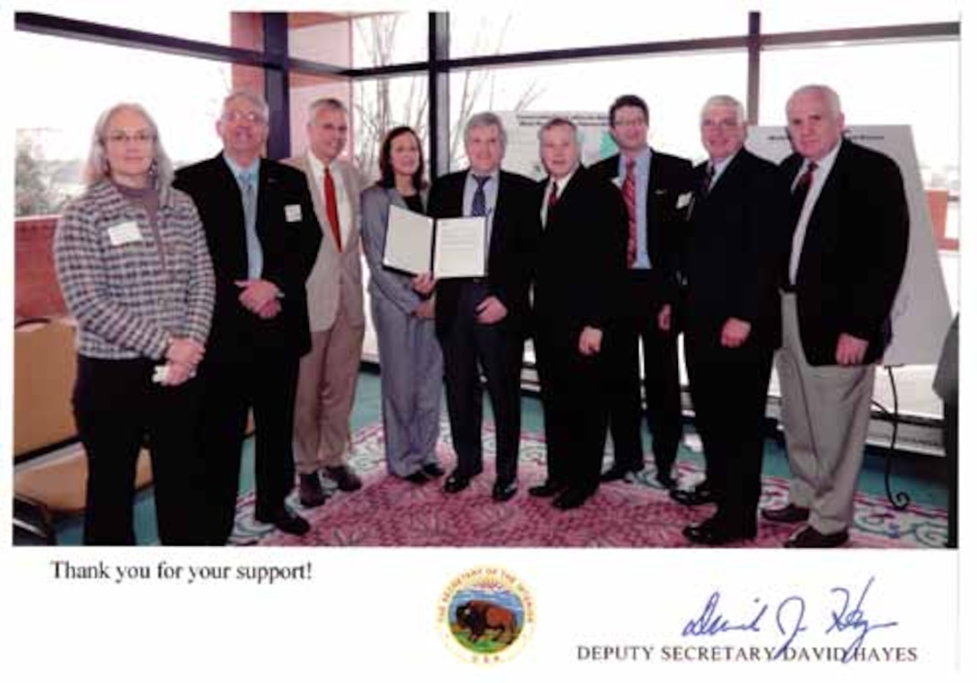 Along with a commemorative copy of the designation document signed by the Secretary
of the Interior Ken Salazar, Deputy Secretary of the Interior David J. Hayes (Center) sent
this “thank you” photo taken at the designation ceremony Jan. 9 in Little Rock, Ark. The Honorable Terrence “Rock” Salt, principal deputy assistant secretary of the Army for Civil Works is on the far right.