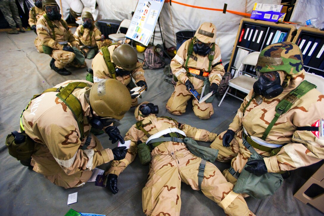 Airmen prepare to use an auto-injector on a simulated nerve agent casualty during a readiness exercise on McEntire Joint National Guard Base, S.C., May 4, 2013.  