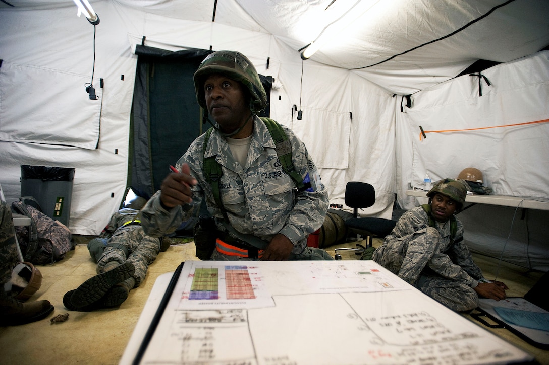 Air Force Chief Master Sgt. Anthony Stovall, center, accounts for personnel during a readiness exercise on McEntire Joint National Guard Base, S.C., May 5, 2013. 