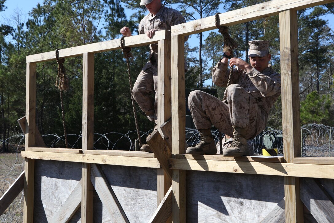 Students of Marine Corps Engineer School go through obstacles of the Engineers Course at Courthouse Bay aboard Marine Corps Base Camp Lejeune. They were there to add some finishing touches in a two-year restoration of the course.