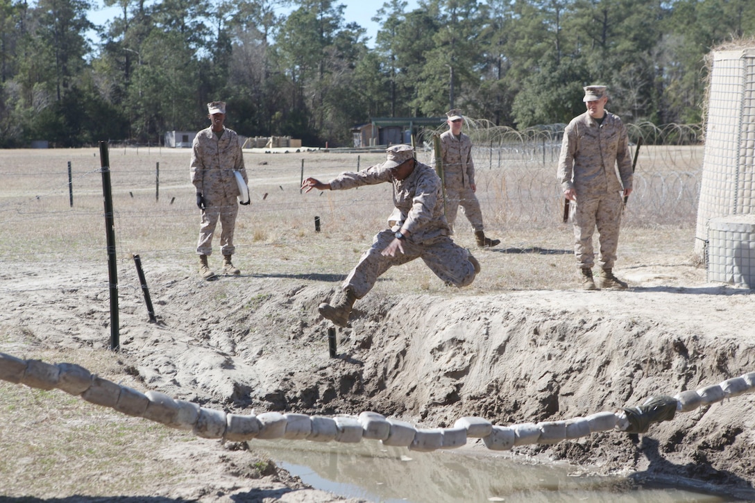 Students of Marine Corps Engineer School go through obstacles of the Engineers Course at Courthouse Bay aboard Marine Corps Base Camp Lejeune. They were there to add some finishing touches in a two-year restoration of the course.