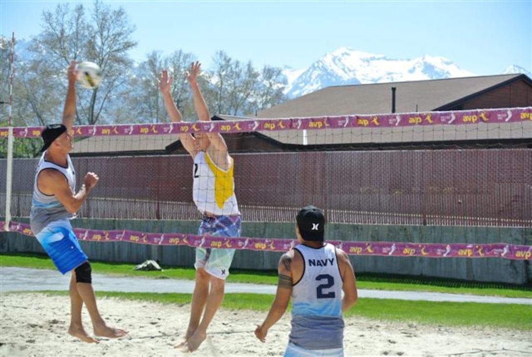Navy Team #1's AWRCS John Goings (Jacksonville, FL) lands a spike against Army Team #2's SFC Eric Latson (JB Lewis-McChord, WA) at the 2013 Armed Forces Beach Volleyball Championship at Hill AFB, UT
