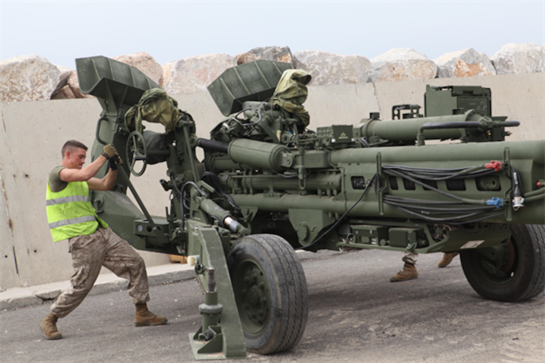 Corporal Kyle W. Daley cranks settings on a M777 Howitzer cannon here on April 11, 2013. Daley, 22, and other servicemembers were here to prepare for the beginning of African Lion 2013. Daley, is a cannon crewman assigned to Q Battery, 5th Battalion, 14th Marine Regiment. Exercise African Lion is a U.S. Africa Command-scheduled, U.S. Marine Corps Forces Africa- led, joint multi-lateral exercise. The joint task force consisting of U.S. Marines, soldiers, sailors and airmen were able to conduct modified joint training for Exercise African Lion 13, demonstrating their ability to adapt to unpredicted circumstances, restore mission essential tasks, build interoperability and create friendships during the remaining days of the evolution. The logistics component will continue to exercise vigilant, safe and rapid retrograde of almost 1,200 personnel and 250 short-tons of vehicles and equipment while working with Moroccan partners and contractors to sustain the force and redeploy them back to their home stations in a timely and efficient manner.