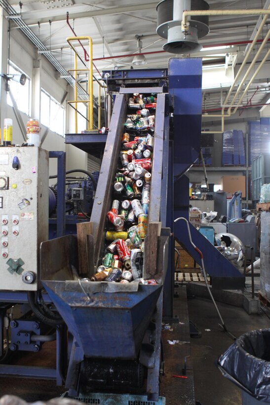 Aluminum cans move up the conveyor belt of a can compactor at the station recycling center here, April 8, 2013. The mantra of ‘recycle, reduce, and reuse,’ conveys the necessity of reducing unnecessary garbage. Segregation is also an integral part of the process. As residents sort through their garbage, they take an account of what they are and are not recycling.