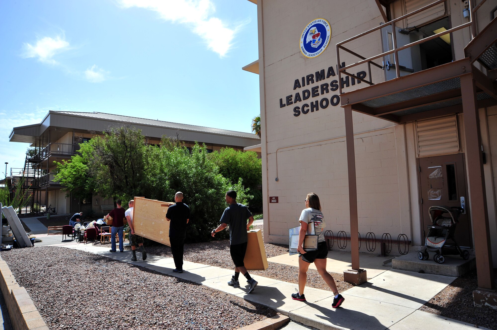 Volunteer ALS students spent about three hours loading a truck with furniture from the ALS building at Davis-Monthan Air Force Base, Ariz., May 4, 2013. The furniture donated by ALS will be used to furnish rooms and provide a home for a couple of the homeless veterans in Tucson.(U.S. Air Force photo by Airman 1st Class Josh Slavin/Released)