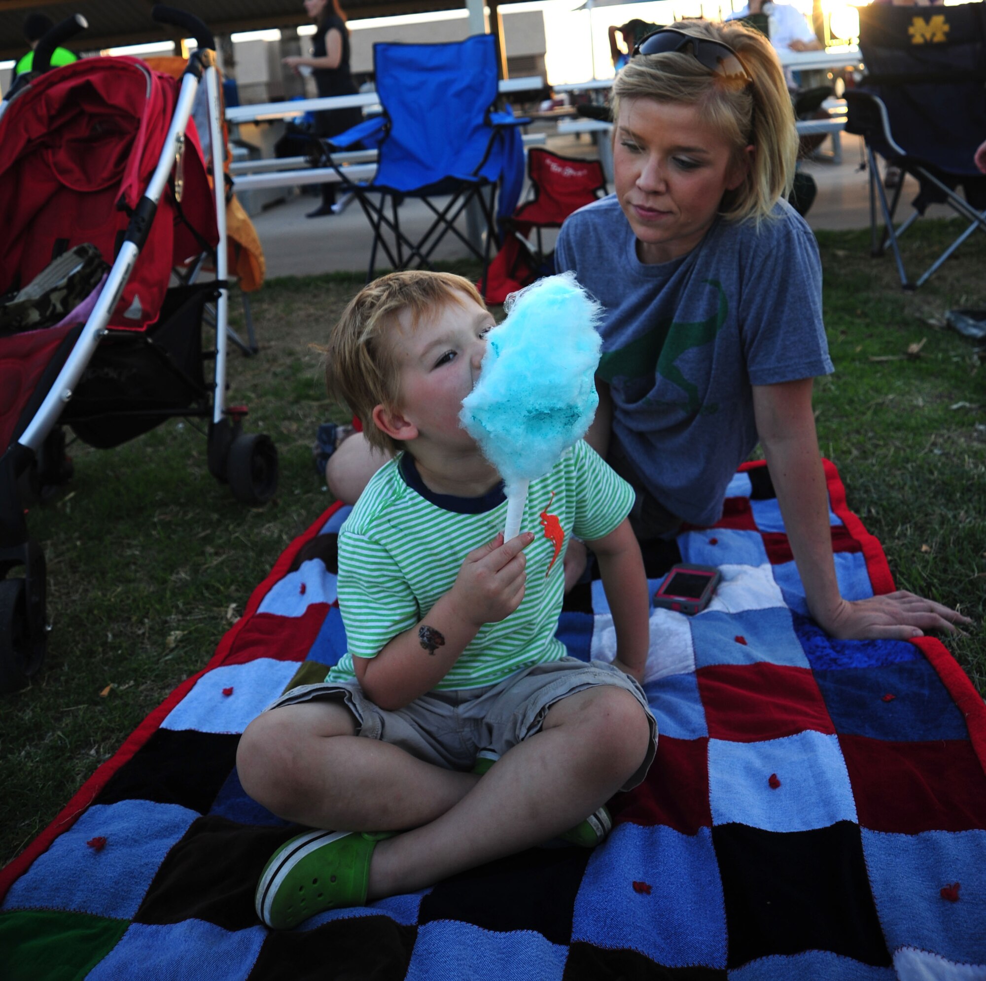 Henry Koch eats cotton candy with his mom, Staff Sgt. Caitlin E. Jones, 355th Fighter Wing broadcast journalist, at Movie-in-a-Park event May 4, 2013 at Davis-Monthan Air Force Base, Ariz. The base event was free to all Desert Lightning Team members and included games and a screening of “Monsters Inc.” (U.S. Air Force photo by Senior Airman Camilla Griffin/released)