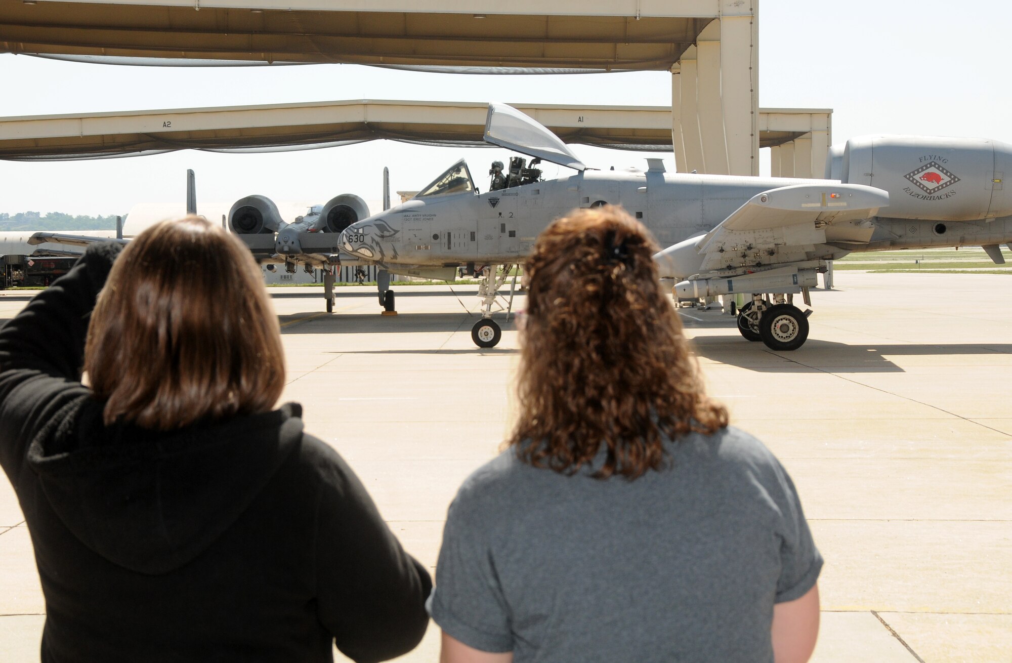 A group of teachers from Westwood Elementary in Greenwood, Ark, watch A-10C Thunderbolt II “Warthogs” taxi following a training mission. The teachers toured the 188th Fighter Wing April 29. They received a mission briefing from Lt. Col. Brian Burger, 188th Operations Group commander, and got the chance to learn about the A-10s wartime role. (U.S. Air National Guard photo by Senior Airman John Hillier/188th Fighter Wing Public Affairs)