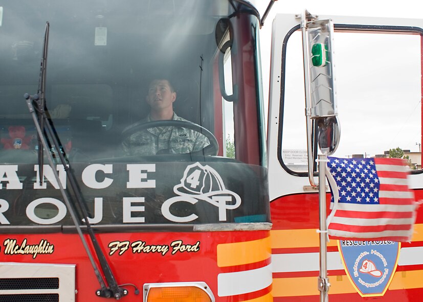 U.S. Air Force Airman 1st Class Hunter Salge, 7th Civil Engineer Squadron, sits in the driver seat of the Remembrance Rescue Project's "Res4cue" May 8, 2013, at the fire department on Dyess Air Force Base, Texas. The Remembrance Rescue Project allows Res4cue, the single remaining rescue unit from New York City in service immediately after the terror attacks, to serve as a mobile memorial to educate, honor and remember the events of Sept. 11, 2001, and all fallen firefighters throughout the country. Res4cue was parked two blocks east of the south tower when the collapse occurred. The names of firefighters who died while serving as part of Res4cue and Res3cue on 9/11, are written on the doors of the fire truck. The project stopped at Dyess while in Abilene, Texas, on a national tour visiting schools, community events and memorials, to pay tribute to the many lives lost and to always remember the events that took place on 9/11. (U.S. Air Force photo by Airman 1st Class Peter Thompson/Released)