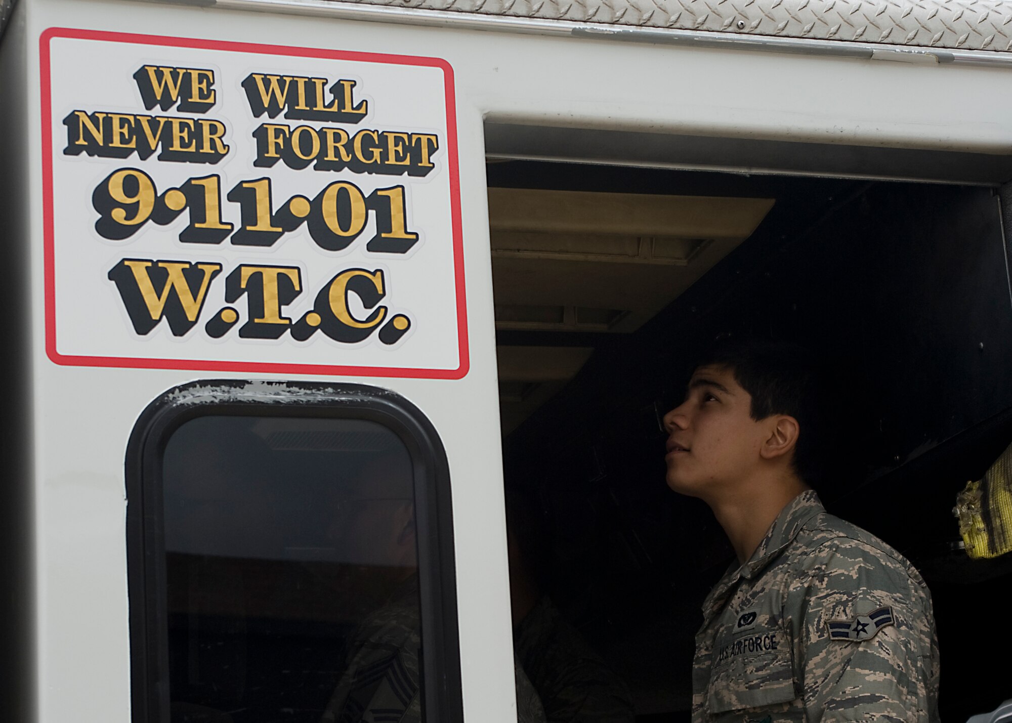 U.S. Air Force Airman 1st Class Aaron Cooper, 7th Civil Engineer Squadron, looks around the interior of the Remembrance Rescue Project's "Res4cue" May 8, 2013, at the fire department on Dyess Air Force Base, Texas. The Remembrance Rescue Project allows Res4cue, the single remaining rescue unit from New York City in service immediately after the terror attacks, to serve as a mobile memorial to educate, honor and remember the events of Sept. 11, 2001, and all fallen firefighters throughout the country. Res4cue was parked two blocks east of the south tower when the collapse occurred. The names of firefighters who died while serving as part of Res4cue and Res3cue on 9/11, are written on the doors of the fire truck. The project stopped at Dyess while in Abilene, Texas, on a national tour visiting schools, community events and memorials, to pay tribute to the many lives lost and to always remember the events that took place on 9/11. (U.S. Air Force photo by Airman 1st Class Peter Thompson/Released)