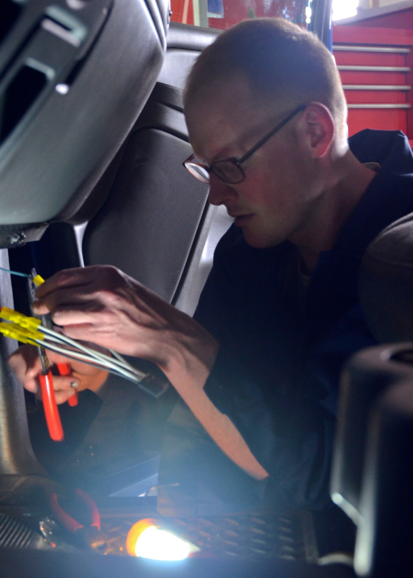 Missouri Air National Guard Senior Airman John Hall, of the 131st Logistics Readiness Squadron, replaces the wiring inside one of the 509th Bomb Wing’s trucks during the unit training assembly on May 4. (U.S. Air National Guard photo by Staff Sgt. Sean Navarro/RELEASED)