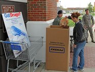 Members of Team Scott drop off their expired or unused medications April 26 at the commissary. Team Scott collaborated with the Drug Enforcement Administration to host a National Take Back Day for safe disposal of unused medication. (U.S. Photo by Senior Airman Divine Cox)