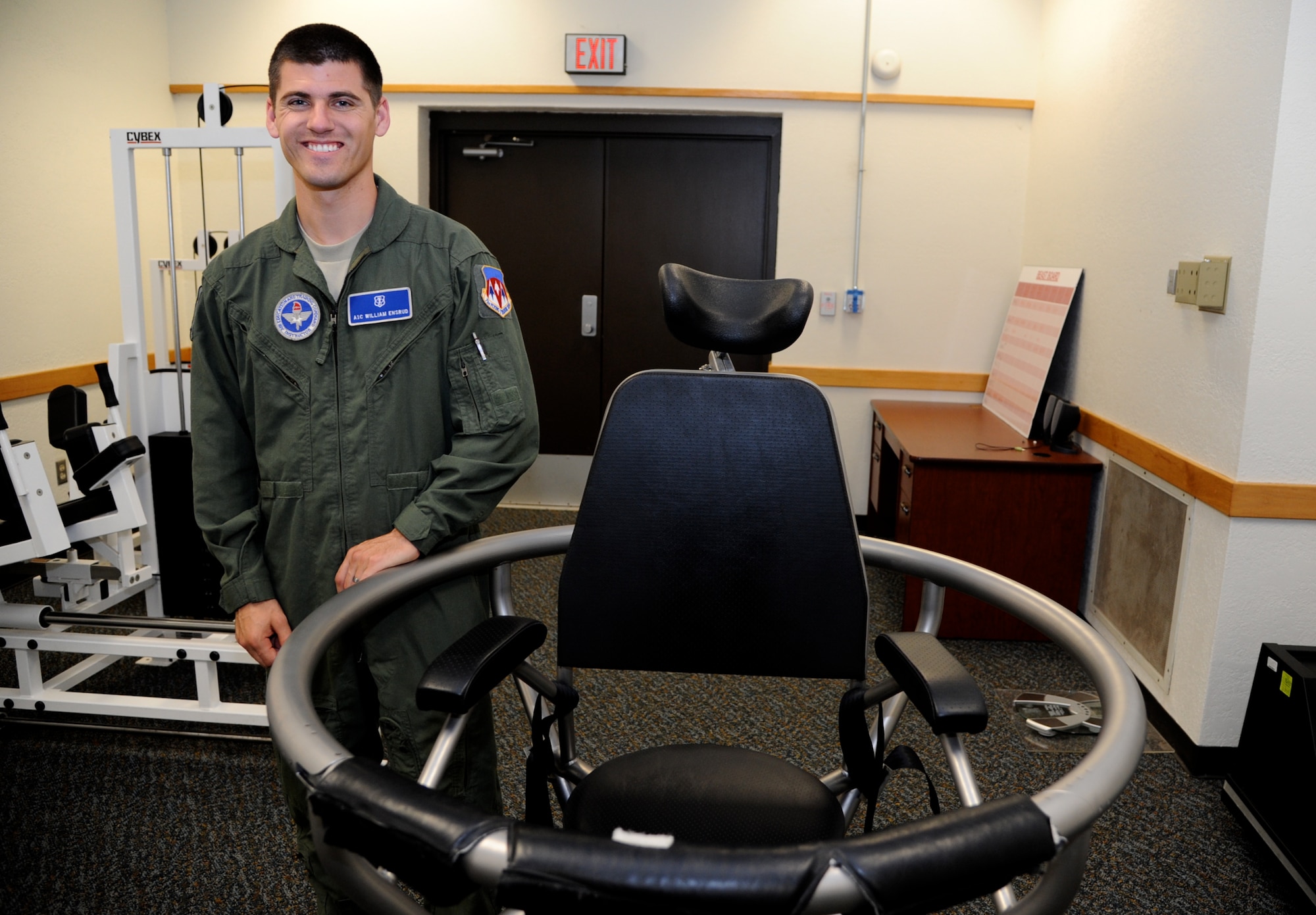 Airman 1st Class William Ensrud, an aerospace physiology technician with the 71st Medical Operations Squadron, stands with a Barany chair at Vance Air Force Base, Okla. Ensrud teaches student pilot egress procedures, the use of aircraft life support equipment, how to cope with high-altitude conditions, parachute landing falls and air sickness prevention. (U.S. Air Force photo/Senior Airman Frank Casciotta) 