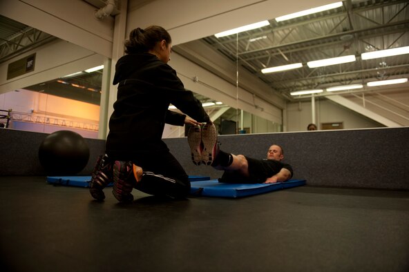 U.S. Air Force Airman Chloe Roze, 366th Comptroller Squadron customer service technician, sets a target for Airman 1st Class Shane M. Phipps, 366th Fighter Wing public affairs photojournalist, May 7, 2013, at Mountain Home Air Force Base, Idaho. Physical fitness is a crucial part of the Air Force mission. (U.S. Air Force photo by Senior Airman Heather Hayward/Released) 