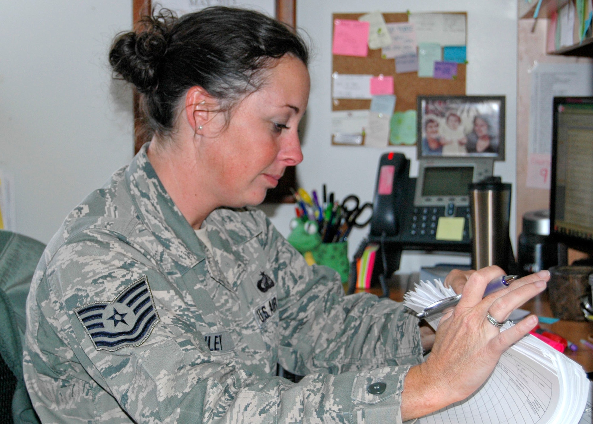 Missouri Air National Guard Tech. Sgt. Mandy Pauley, of the 131st Bomb Wing works to resolve a customer’s pay issue at Whiteman Air Force Base, Mo., May 5.   (U.S. Air National Guard photo by Staff Sgt. Traci Payne/RELEASED)