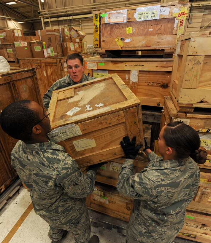 Airman 1st Class Brandon Scott, Airman 1st Class Jordan Fishburne and Senior Airman Brenda Hawkins, 28th Logistics Readiness Squadron aircraft parts technicians, stack a B-1 brake onto a pallet during an inventory in the Aircraft Parts Store on Ellsworth Air Force Base, S.D., April 30, 2013. The mobility readiness spares packages contain a variety of B-1 parts and must be strategically stacked to ensure all necessary parts fit on the pallet and properly distribute the weight. (U.S. Air Force photo by Airman 1st Class Kate Thornton-Maurer/Released) 
