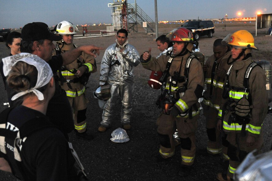Chief David Givens, 56th Civil Engineer Squadron fire emergency services member, briefs Luke firemen April 15 during night fire training at the Luke Air Force Base fire training grounds. (U.S. Air Force photo/Senior Airman Sandra Welch)