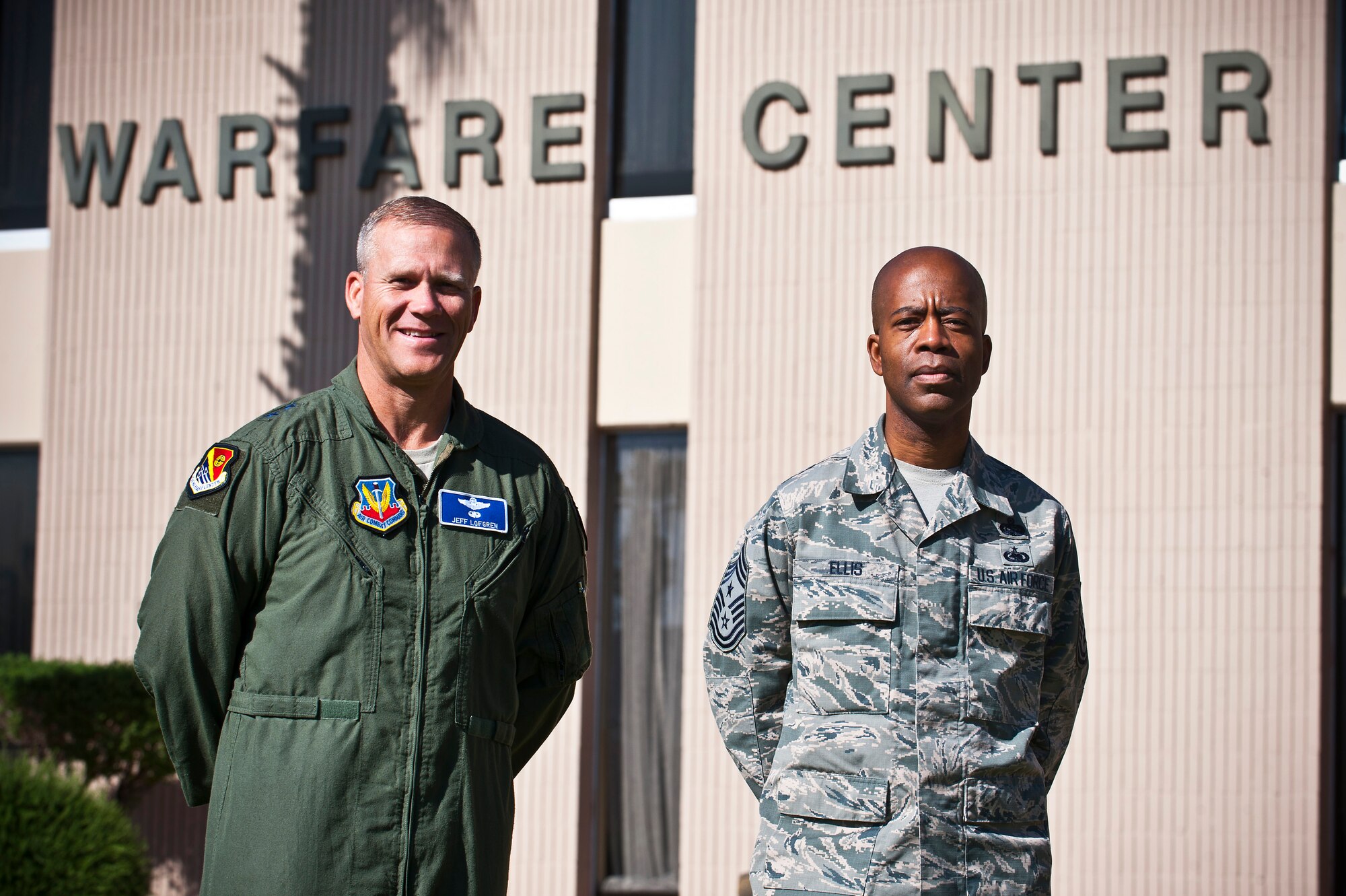 Maj. Gen Jeffrey Lofgren (left), U.S. Air Force Warfare Center commander, and Chief Master Sgt. Robert Ellis, USAFWC command chief stand in front of the Warfare Center April 16, 2013, on Nellis Air Force Base, Nev. USAFWC's leadership has directed an installation–wide Financial Resilience Education Day May 3. During this day the Nellis Airman and Family Readiness Center will provide seminars, activities and education events to all Airmen and Department of Defense civilian contractors in order to emphasize the importance of financial resilience. (U.S. Air Force photo by Senior Airman Brett Clashman)