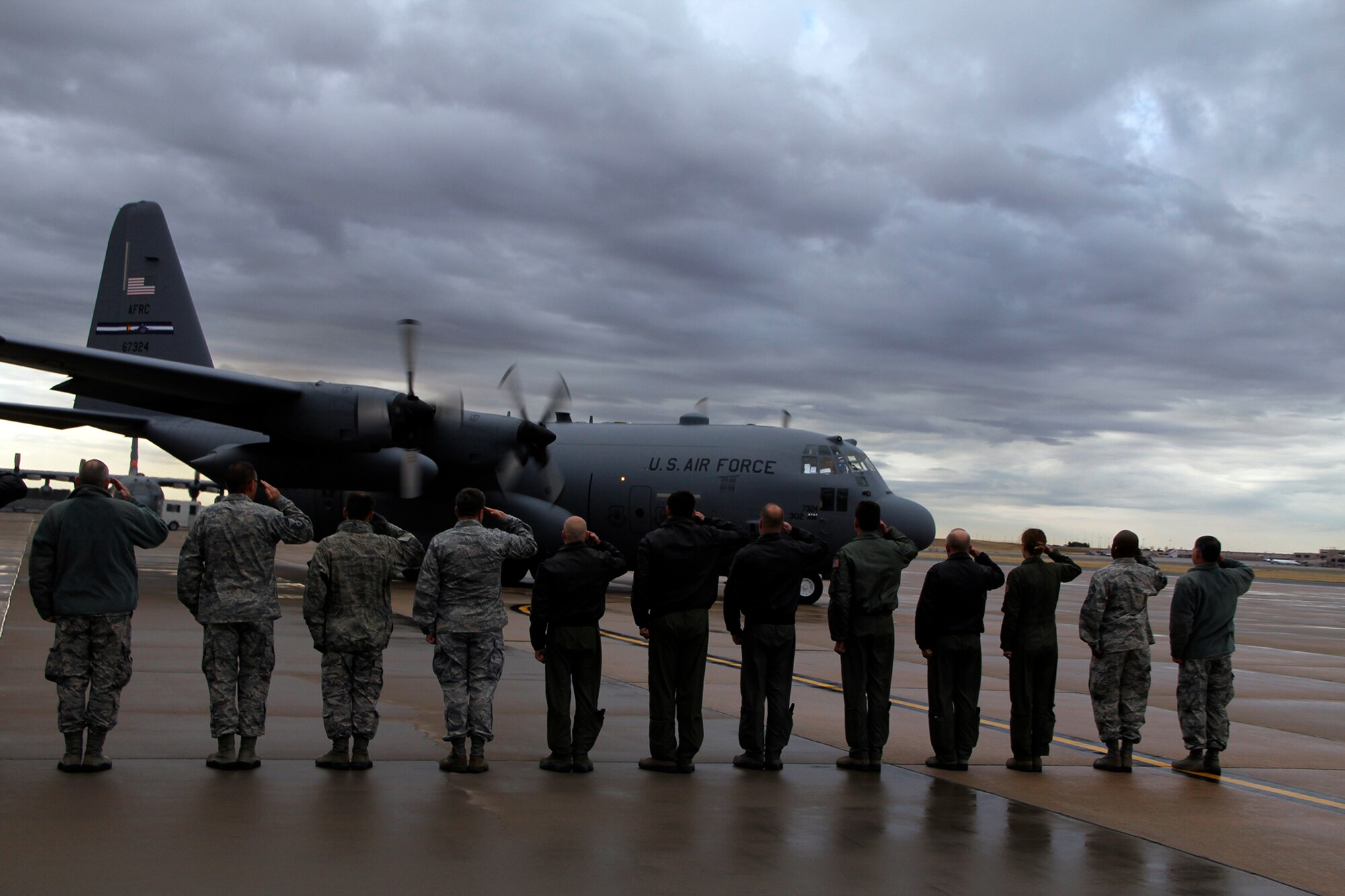 PETERSON AIR FORCE BASE, Colo. – Leadership from the Air Force Reserve Command’s 302nd Airlift Wing and active duty’s 52nd Airlift Squadron salute a 302nd AW C-130 Hercules as it departs here May 8 for a deployment to Southwest Asia in support of Operation Enduring Freedom. This is the first time the Peterson Air Force Base assigned Reserve and active duty flying squadrons’ deployments will coincide since the active duty’s 52nd AS partnered with the Reserve wing in October 2009 as part of the U.S. Air Force's Total Force Integration initiative. (U.S. Air Force photo/Staff Sgt. Nathan Federico)