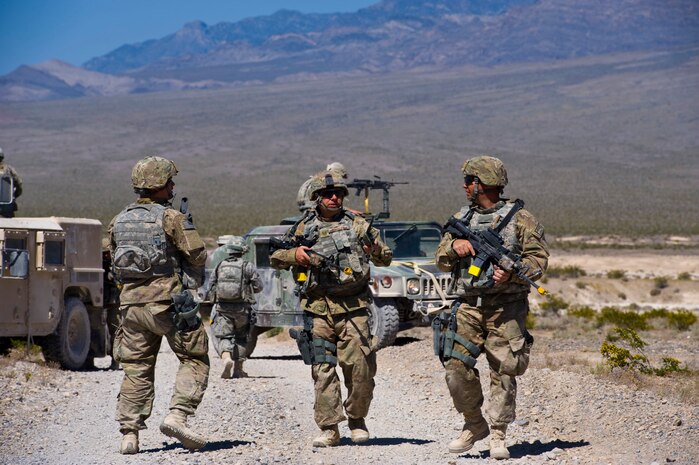 Security forces Airmen discuss operation procedures during an urban operations training course May 1, 2013, at Nellis Air Force Base, Nev. The Airmen are evaluated on setting up a perimeter and tactically patrolling the area. (U.S. Air Force photo by Airman 1st Class Christopher Tam)