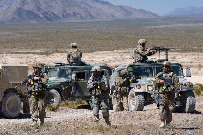 Security forces Airmen perform a dismounted patrol during an urban operations training course May 1, 2013, at Nellis Air Force Base, Nev. The 99th Ground Combat Training Squadron makes sure realism is a key element when conducting the course. (U.S. Air Force photo by Airman 1st Class Christopher Tam)