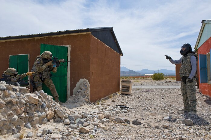 Security forces Airmen react to a detainee during urban operations training course April 30, 2013, at Nellis Air Force Base, Nev. The course trains security forces Airmen, primarily to Air Combat Command Airmen, but is open to all major commands on how to react to attacks, handle detainees, and how to safely approach and secure buildings. (U.S. Air Force photo by Airman 1st Class Christopher Tam)