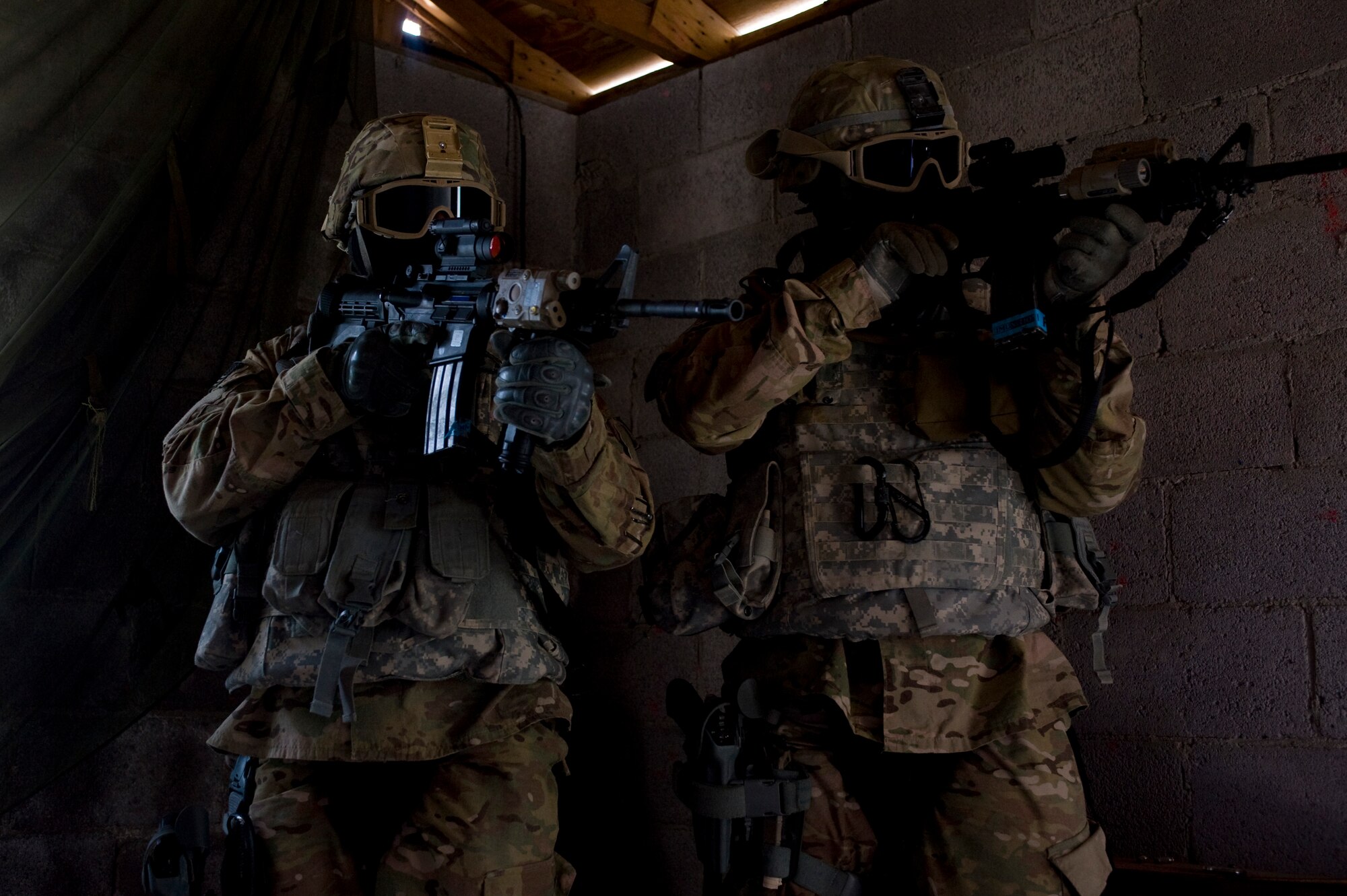 Security forces Airmen search a house for the enemy during an urban operations training course April 30, 2013, at Nellis Air Force Base, Nev.  Instructors from the 99th Ground Combat Training Squadron teach the course primarily to Air Combat Command Airmen, but are open to all major commands around the Air Force. (U.S. Air Force photo by Airman 1st Class Christopher Tam)