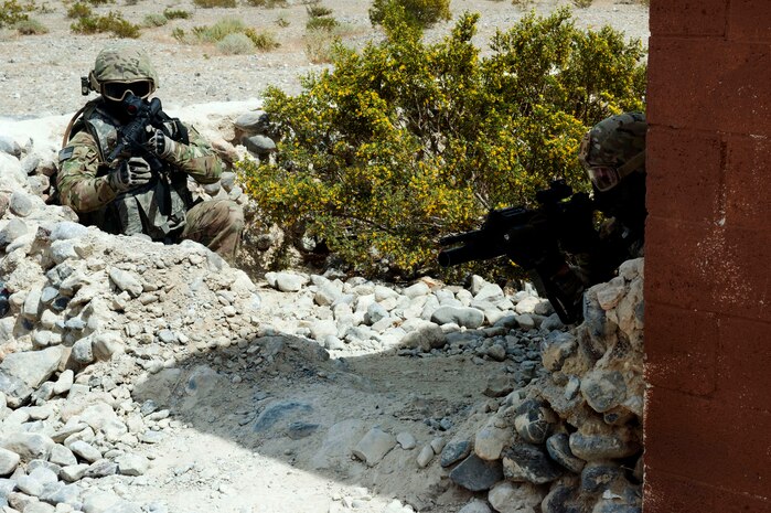 Security forces Airmen hold a defensive position during pre-deployment training at the military operations in urban terrain training village outside of Nellis Air Force Base, Nev., April 30, 2013. Integrated defense instructors from the 99th Ground Combat Training Squadron teach effective urban combat tactics to ensure safety and mission accomplishment to Airmen primarily from Air Combat Command and other major commands (U.S. Air Force Photo by Staff Sgt. Gregory Brook.) 