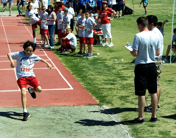 Airmen assigned to Nellis Air Force Base, Nev., judge the long jump competition at the 2013 Special Olympics held at Cheyenne High School in North Las Vegas May 3, 2013. Approximately 80 Nellis Airmen volunteered to staff, setup and tear down the event.  (U.S. Air Force Photo by Benjamin Newell)