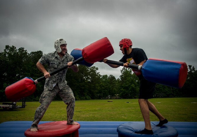 Airman 1st Class Joshua Wachtel, 628th Logistics Readiness Squadron maintenance specialist (left), tries to knock Airman 1st Class Roberto Ladino, 628th LRS maintenance specialist, off his platform during a pugil stick battle at the Joint Base Charleston Base Picnic May 3, 2013. The base picnic was a free two-day event which included food, drinks and a live band for all Team Charleston members and their families to enjoy. (U.S. Air Force photo/ Senior Airman Dennis Sloan)