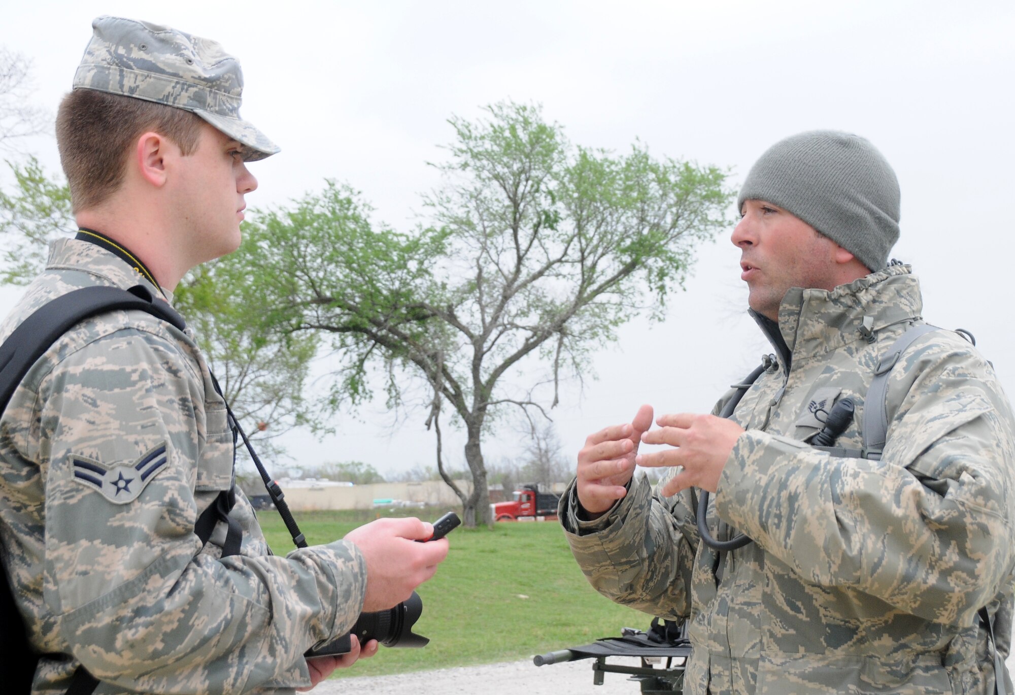 Airman 1st Class Cody Martin, a 188th Fighter Wing photojournalist, interviews Staff Sgt. James Hammock of the 238th Chemical Company, Indiana National Guard, about his part in the Vigilant Guard exercise. Martin helped document the exercise and provided photo and video products to units and civilians in six states. (U.S. Air National Guard photo by Senior Airman John Hillier/188th Fighter Wing Public Affairs)